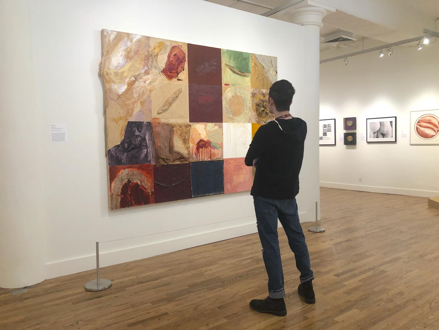 Liam Otero FCRH '20 looks at a work of art at the exhibit. (Sophia Giatzis/ The Fordham Ram)